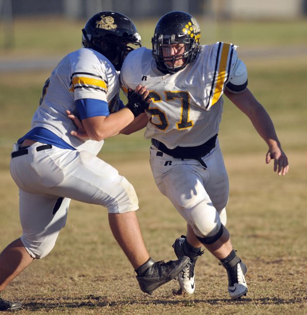 Jacob Kahl, right, of Prairie Grove runs drills during practice Wednesday afternoon in Prairie Grove. Kahl’s intensity has helped the Tigers remain unbeaten this season. 