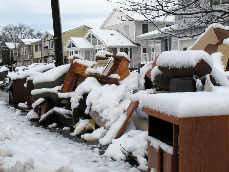 Four inches of snow covers piles of debris from superstorm Sandy in Point Pleasant Beach, N.J., on Thursday Nov. 8, 2012, a day after a nor'easter hit the storm-weary state. Emergency dunes seemed to have held during the recent storm, and flooding that had been feared did not materialize. 