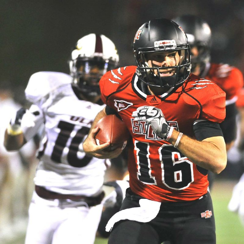 Arkansas State quarterback Ryan Aplin (16) outruns Louisiana-Monroe safety Cordero Smith (10) for a 38-yard first-quarter touchdown at Liberty Bank Stadium in Jonesboro on Thursday night. 