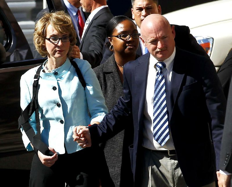Gabrielle Giffords leaves court Thursday in Tucson, Ariz., with her husband, Mark Kelly, after Jared Loughner’s sentencing in the shooting that left six people dead and 13, including Giffords, wounded. “After today, after this moment, Gabby and I are done thinking about you,” Kelly told Loughner at the hearing. 