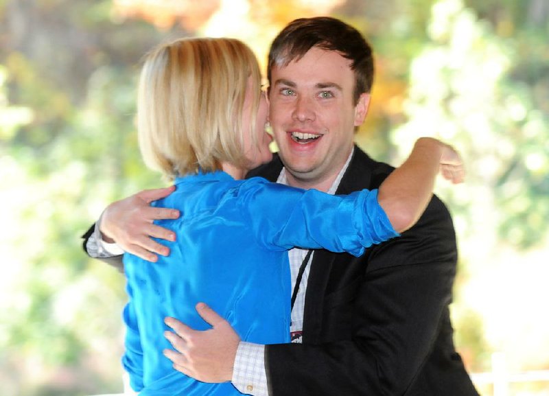 Sara Beck and Will Carter of tech startup company Btiques congratulate each other Thursday after winning $150,000 in investment funding during the ARK Challenge’s Demo Day at Crystal Bridges Museum of American Art in Bentonville. 