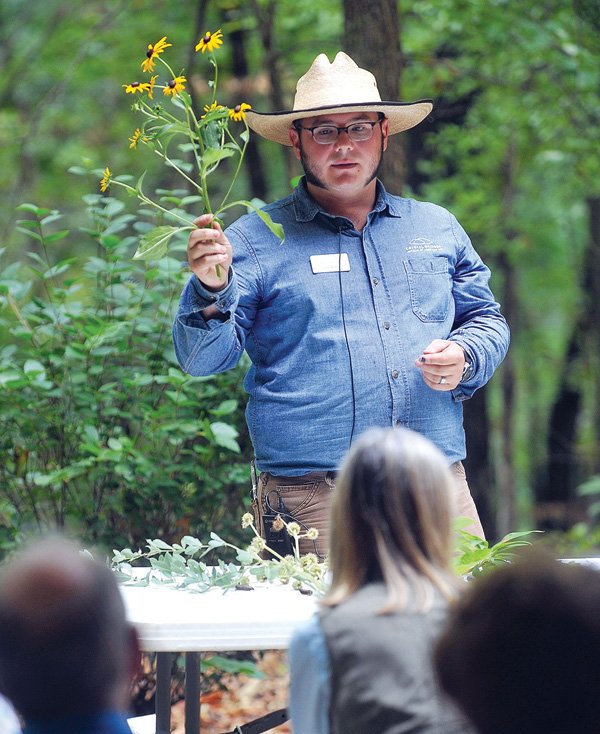 Cody George, Crystal Bridges field horticulturist, speaks about the local plants to those in attendance for the program “Discover the Grounds: Preserving the Freshwater Ecosystem at Crystal Bridges.” The museum hosts many such events on the surrounding grounds. 