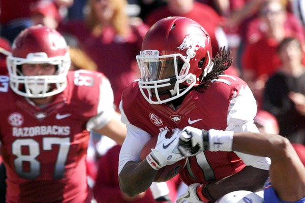 Arkansas wide receiver Cobi Hamilton (left) already has caught a school-record 69 passes this season and has now set his sights on a new yardage record for the Razorbacks with three games left. 