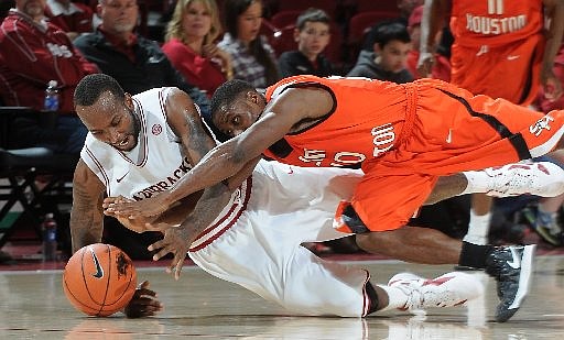 NWA MEDIA/SAMANTHA BAKER -- Arkansas' Marshawn Powell (left) and Jeremy McKay from Sam Houston State dive for the ball during the second half of the men's season opener Friday, Nov. 9, 2012, at Bud Walton Arena in Fayetteville.