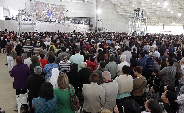 A crowd attends a Mass led by Catholic priest Marcelo Rossi at the Mother of God sanctuary in Sao Paulo, Brazil. Rossi, a Latin Grammy-nominated Christian music singer, inaugurated the massive new Roman Catholic church on Nov. 2. It will hold about 20,000 worshippers when complete. 