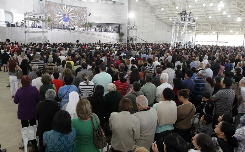 A crowd attends a Mass led by Catholic priest Marcelo Rossi at the Mother of God sanctuary in Sao Paulo, Brazil. Rossi, a Latin Grammy-nominated Christian music singer, inaugurated the massive new Roman Catholic church on Nov. 2. It will hold about 20,000 worshippers when complete. 