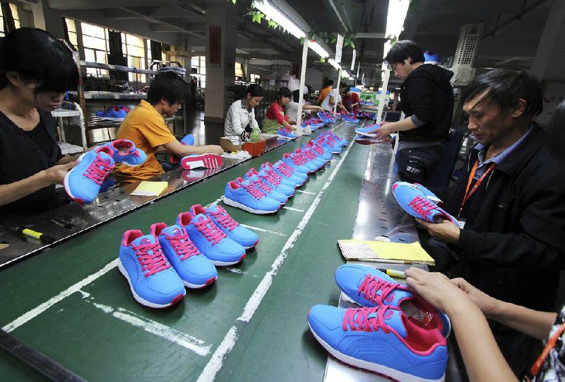 Chinese workers assemble shoes Friday at a factory in Jinjiang. Economic statistics released by the Chinese government Friday showed a return to fairly strong economic expansion. 
