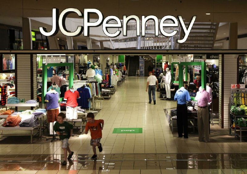 Shoppers mill about in a J.C. Penney store in Plano, Texas. The retailer on Friday reported a loss of $123 million in the three months that ended Oct. 27.
