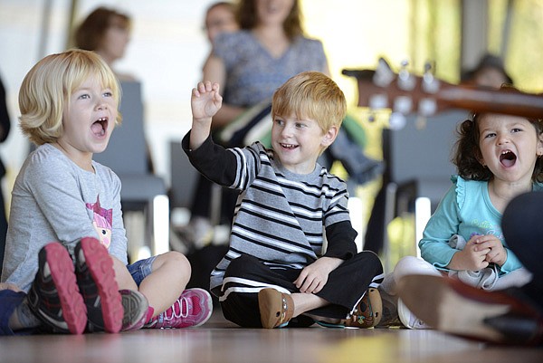 Anika Platvoet of Owasso, Okla., Ethan Swint, 4, of Rogers and Ameera Abdelfattah, 3, of Bentonville sing along Oct. 18 with musician Shannon Wurst to a song about spinach during the monthly “Preschool Playdate!” event at Crystal Bridges Museum of American Art in Bentonville. 