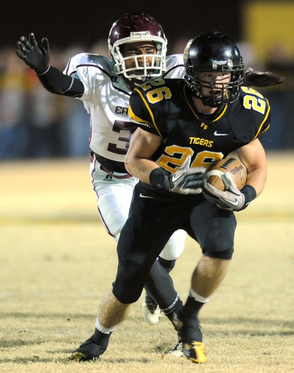 Logan Bartholomew, a Prairie Grove junior, carries the ball as Crossett junior Imani Sias reaches to make the tackle Friday during the first half at Tiger Stadium in Prairie Grove. 