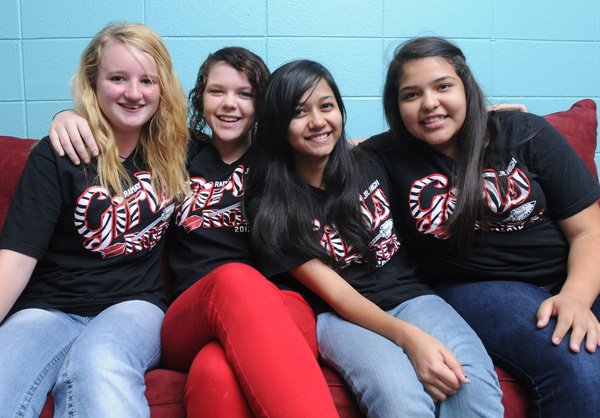 Breanna Boyd, 15, from left, Kaitlin Ahrens, 15, Tasfia Jahangir, 14, and Esmeralda Martinez, 14, members of Ramay Girls Rock, gather Friday at Ramay Junior High School prepare for a fundraiser the group will host Monday at Powerhouse Seafood & Grill in Fayetteville. Money from the fundraiser goes to benefit Safety Net. 