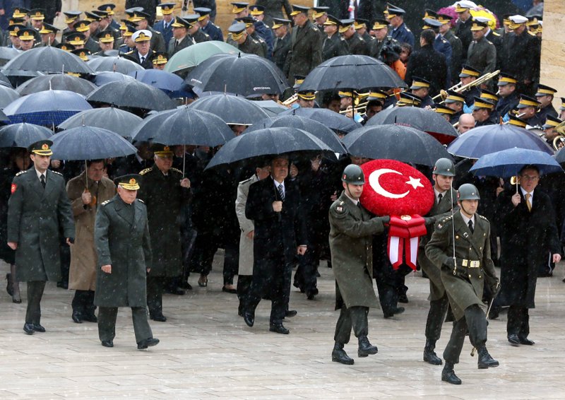 Turkish President Abdullah Gul, center, ministers and army commanders follow a guard of honour at the mausoleum of Turkey's founder Kemal Ataturk during a ceremony marking the 74th anniversary of his death in Ankara, Turkey, Saturday, Nov. 10, 2012. Turkish media say 17 soldiers have been killed in a helicopter crash early Saturday in Siirt province in the country’s southeast. State-run TRT television said the crash occurred in heavy fog in a mountainous area.