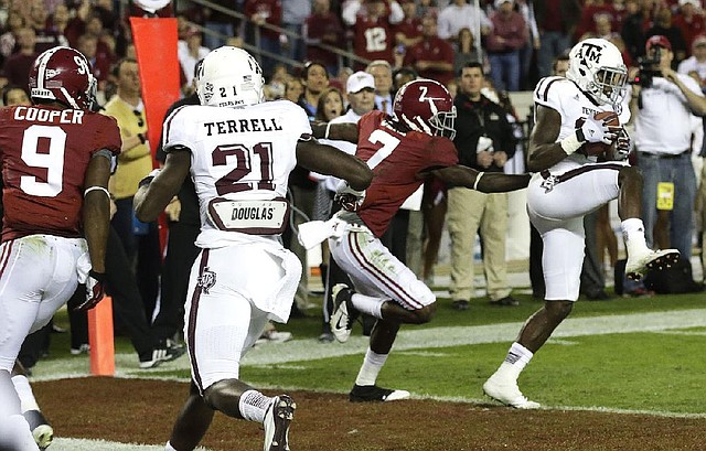 Texas A&M defensive back Deshazor Everett (29) intercepts a pass from Alabama quarterback AJ McCarron intended for Kenny Bell (7) to stop a Crimson Tide drive in the fourth quarter of Saturday’s game at Bryant-Denny Stadium in Tuscaloosa, Ala. 
