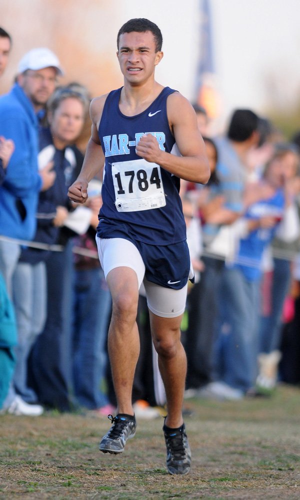 Dino Andrade, from Springdale Har-Ber heads down the final stretch Saturday during the Class 7A State Boys Cross Country Championships at Oaklawn Park in Hot Springs. 