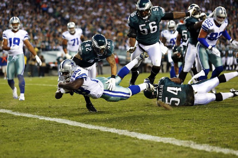 Dallas Cowboys running back Felix Jones (28) dives for a touchdown on an 11-yard reception past Philadelphia Eagles free safety Kurt Coleman (42) during Sunday’s game in Philadelphia. Jones rushed for 71 yards on 16 carries and the Cowboys, who knocked Eagles quarterback Michael Vick out of the game in the second quarter with a concussion, won 38-23.