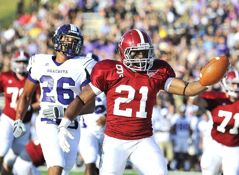 Henderson State running back Jarvis Smith (21) outruns Ouachita Baptist safety Aaron Grant for a touchdown during Saturday’s game. Henderson State won 42-7, earning the outright Great American Conference title and its first NCAA Division II playoff berth. 