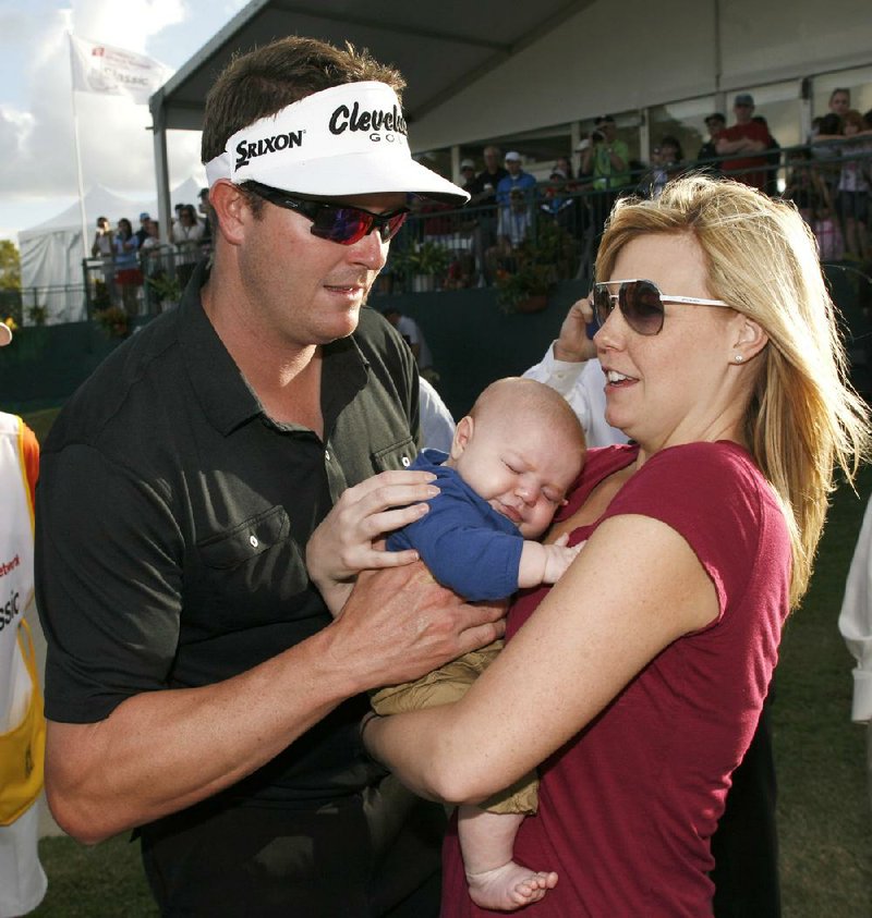 Charlie Beljan (left) celebrates with his wife Merisa and son Graham following Beljan’s PGA Tour victory Sunday in Lake Buena Vista, Fla. 