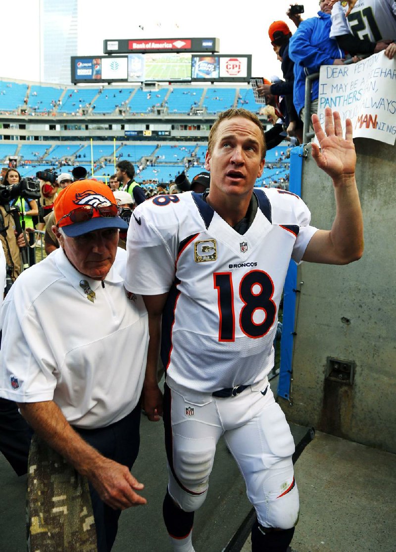 Denver Broncos quarterback Peyton Manning waves to fans after Sunday’s game against the Carolina Panthers in Charlotte, N.C. 