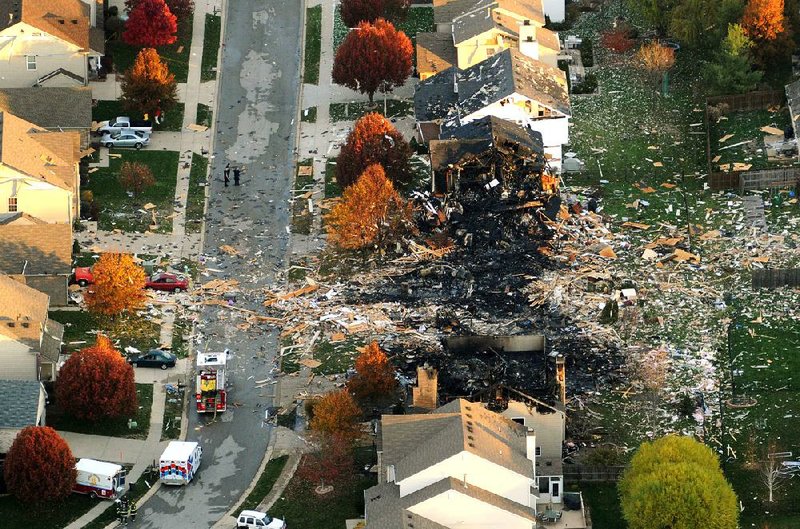 This aerial photo shows the two homes that were leveled and the numerous neighboring houses that were damaged by an explosion that sparked a huge fire and killed two people late Saturday in Indianapolis. Nearly three dozen homes were damaged or destroyed.