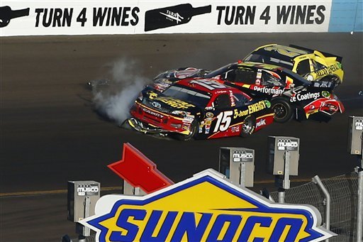 From left, Clint Bowyer (15), Jeff Gordon and Joey Logano crash in Turn 4 during the NASCAR Sprint Cup Series auto race at Phoenix International Raceway, Sunday, Nov. 11, 2012, in Avondale, Ariz. 