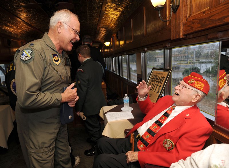 Retired Lt. Col. Steve Gray, military liaison to Sen. John Boozman, R-Rogers, left, speaks Sunday, Nov. 11, 2012, with James L. Quin, 87, of Springdale, a veteran of the U.S. Navy who served in World War II, Korea and Vietnam, during a Veterans Day observance aboard an Arkansas & Missouri Railroad passenger car at the railroad depot in Springdale.