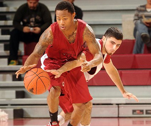 NWA Media/ANTHONY REYES -- Kikko Haydar (20) reaches in on red team's DeQuavious Wagner (23) during the first half of a scrimmage Tuesday, Oct. 30, 2012 at Bud Walton Arena in Fayetteville. 