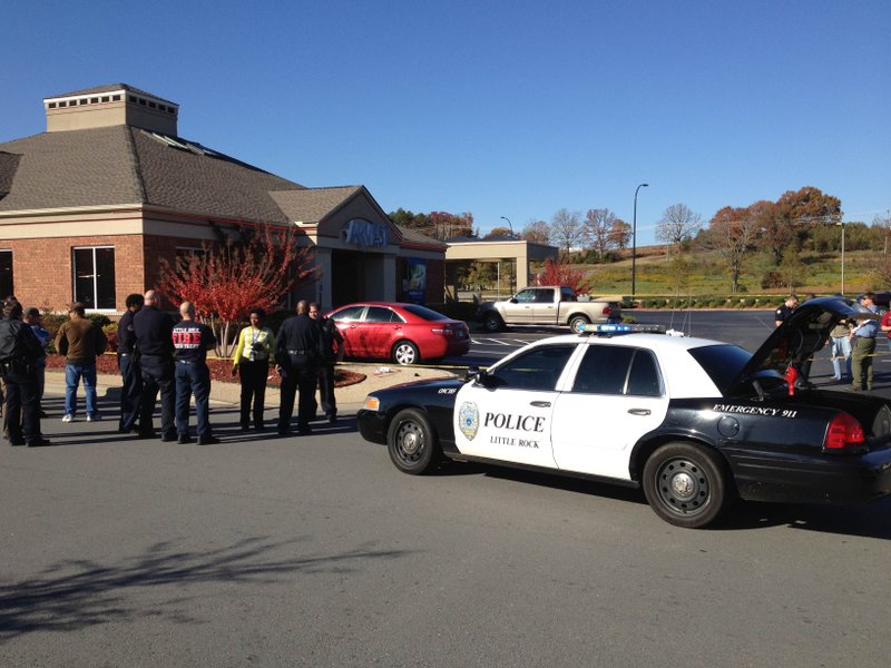 Little Rock police respond to a reported shooting and bank robbery at an Arvest Bank branch at 16107 Chenal Parkway.