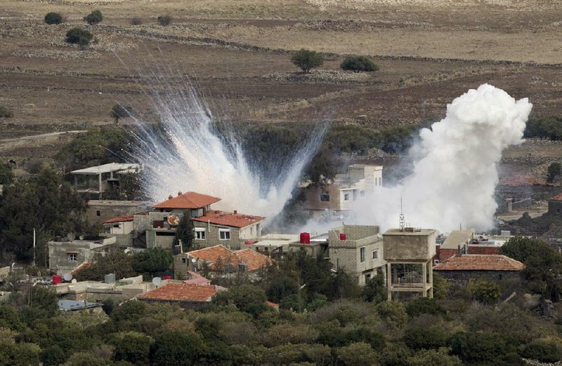 Shells fired by the Syrian army explode Monday in the Syrian village of Bariqa. The Israeli military says Syrian mobile artillery was hit after Israel responded to stray mortar fire from its northern neighbor. The exchange marked the second straight day that Israel has responded to fire from Syria. 
