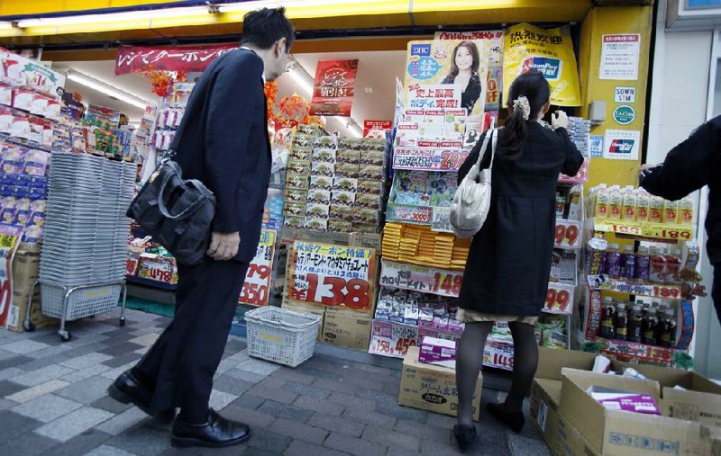 Customers shop at a discount store in Tokyo in October. Japan’s economy shrank 3.5 percent in the July-September quarter, the government reported Monday. 