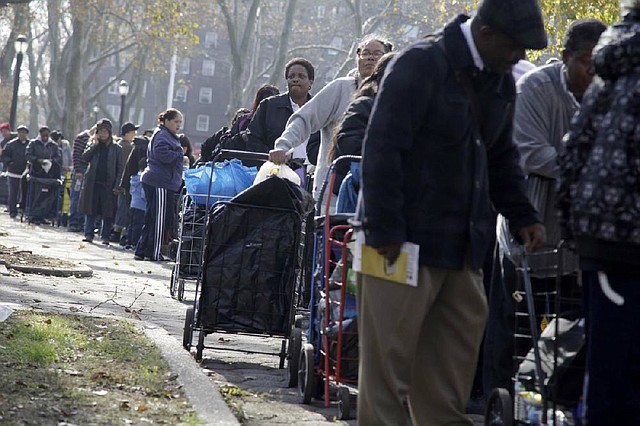 People wait in line Monday for supplies donated to the victims of superstorm Sandy at the Red Hook Houses in Brooklyn, New York. 