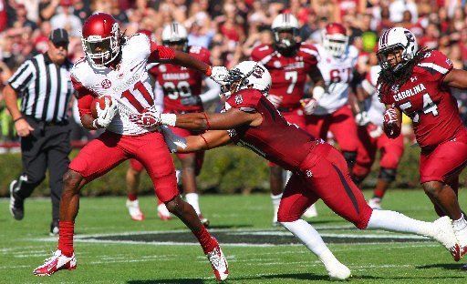 Arkansas Democrat-Gazette/STEPHEN B. THORNTON -- Arkansas' Cobi Hamilton, (11) runs by South Carolina' DeVonte Holloman , right, during the first quarter of their game Saturday afternoon in South Carolina. 