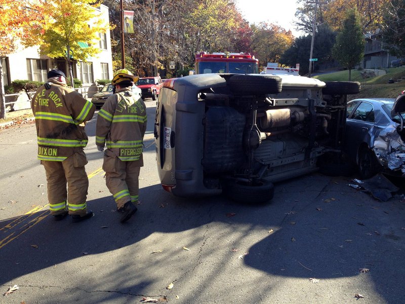 Authorities work the scene Monday, Nov. 12, 2012, of a vehicle wreck on Kavanaugh Boulevard in Little Rock's Hillcrest neighborhood.