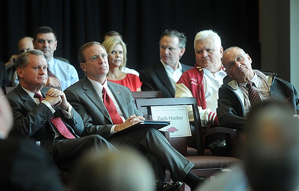 University of Arkansas chancellor G. David Gearhart, from left, athletics director Jeff Long, and former head football coach John L. Smith listen during a Sept. 14, 2012 ceremony for the university's new football center in Fayetteville.