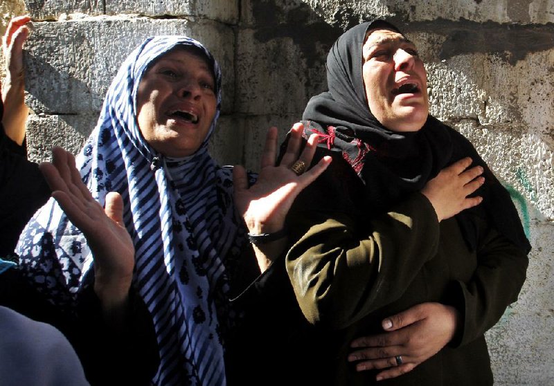 Palestinian women react during the funeral of Hamas militant Mohammed Al Qanoah in Gaza City on Tuesday. A Palestinian health official said Al Qanoah died of wounds received in an Israeli airstrike Saturday. 