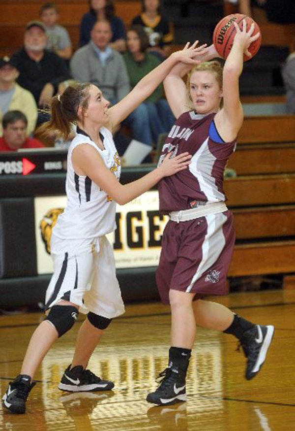 Ashlin Stock, a Siloam Springs junior, tries to drive past Prairie Grove defender Whitnee Fitts during Tuesday’s game in Prairie Grove.