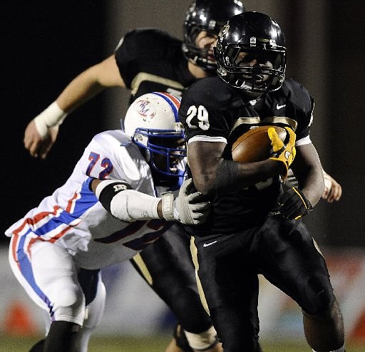 STAFF PHOTO MARC F. HENNING -- Bentonville running back Tearris Wallace, 29, shakes West Memphis defensive end Tristan Williams, 72, during the second quarter of the Tigers' game Friday, Nov. 18, 2011, against the Blue Devils at Tiger Stadium in Bentonville