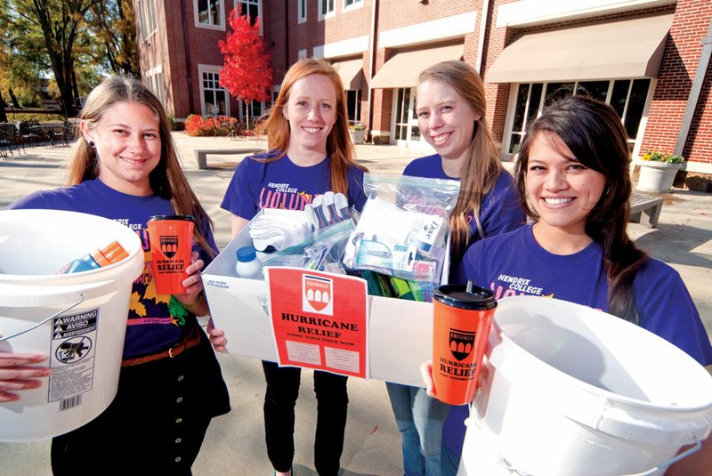 From the left, Lauren DeLano, Michaela Fraser, Erin Murchison and Maia Yang are raising money and collecting supplies for Hurricane Sandy relief through the Volunteer Action Committee at Hendrix College. The relief effort breathed life after Fraser related to the group the story of her parents’ plight following Sandy’s swing through Long Beach, N.Y.