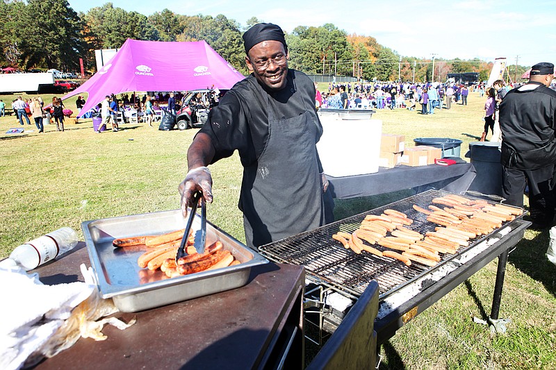 Edward Roy cooks hot dogs for the Henderson State University food tent before the Battle of the Ravine in Arkadelphia.