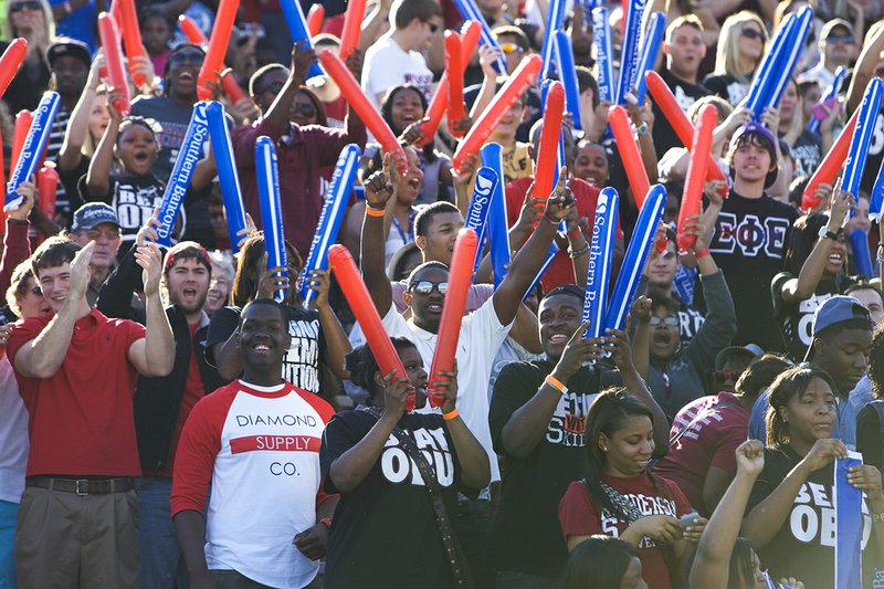 Henderson State University fans cheer for the Reddies during the Battle of the Ravine at Carpenter-Haygood Stadium. Henderson State won the game, 42-7, to complete its first-ever 10-0 season and capture the Great American Conference championship.
