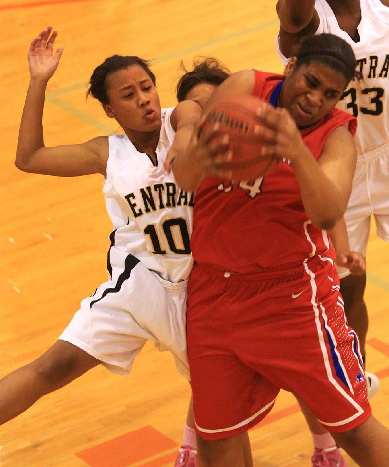 Little Rock Central’s Alaysia Ready (left) and Little Rock Parkview’s Sausha Davey fight for a rebound during the first half of the Tigers’ 53-45 loss to the Patriots on Wednesday at Little Rock Hall High School. 