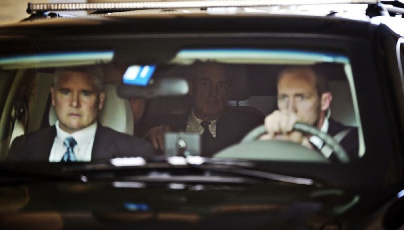 FBI Director Robert Mueller (just visible in back seat) leaves Capitol Hill on Wednesday after a closed session with the House Intelligence Committee on the investigation surrounding the resignation of CIA Director David Petraeus. 