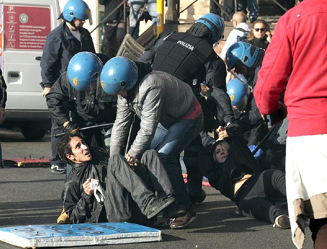 Riot police and protesters clash Wednesday in Rome during a demonstration over austerity measures.