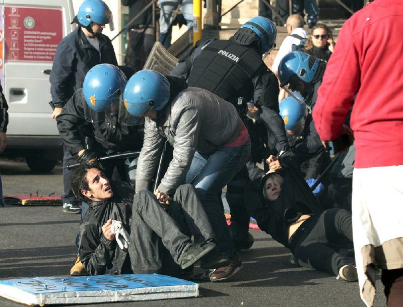 Riot police and protesters clash Wednesday in Rome during a demonstration over austerity measures.