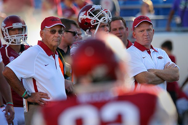 Arkansas Democrat-Gazette/STEPHEN B. THORNTON -- Arkansas coach John L. Smith, left, and offensive coordinator Paul Petrino, right, before the start of their game with Lousiana-Monroe at War Memorial Stadium in Little Rock.