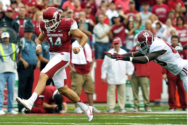 Arkansas punter Dylan Breeding tries to run down an errant first-quarter snap in a 52-0 loss to Alabama in the Razorbacks’ conference-opening loss to the Crimson Tide. Alabama took control on the Arkansas 6 after a penalty on Breeding for illegal kicking. Eddie Lacy scored for the Tide on the next play. 