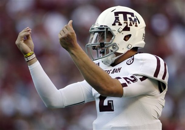 Texas A&M quarterback Johnny Manziel (2) reacts after the Aggies scored their third touchdown of the first quarter against Alabama during the first half of an NCAA college football game at Bryant-Denny Stadium in Tuscaloosa, Ala., Saturday, Nov. 10, 2012. (AP Photo/Dave Martin)