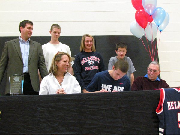 Nick Smith, a Bentonville basketball standout, is surrounded by family members Wednesday afternoon as the 6-foot-8 senior forward signs his national letter of intent with Belmont University. He is joined by his mother, Lisa Smith, seated from left, and grandfather Jack Smith, as well as his father Jeff Smith, standing from left, and younger siblings Ben, Hannah and Simeon Smith. 