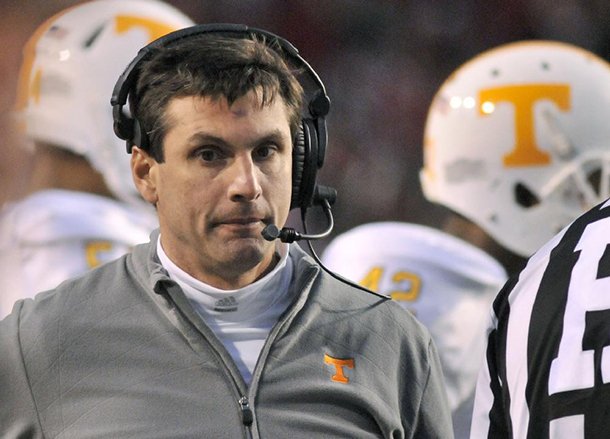 Tennessee coach Derek Dooley walks the sidelines during the first half of an NCAA college football game with Arkansas in Fayetteville, Ark., Saturday, Nov. 12, 2011. (AP Photo/April L. Brown)