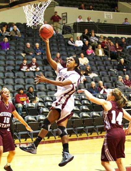 UALR forward Janette Merriex goes up for a shot between two Missouri State defenders during the first half of the Trojans’ 78-68 loss to the Bears on Thursday at the Jack Stephens Center in Little Rock. 