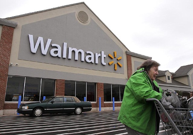 A woman exits a Wal-Mart store in North Kingstown, R.I., on Tuesday. Wal-Mart Stores Inc. on Thursday reported a profit of $3.64 billion. 